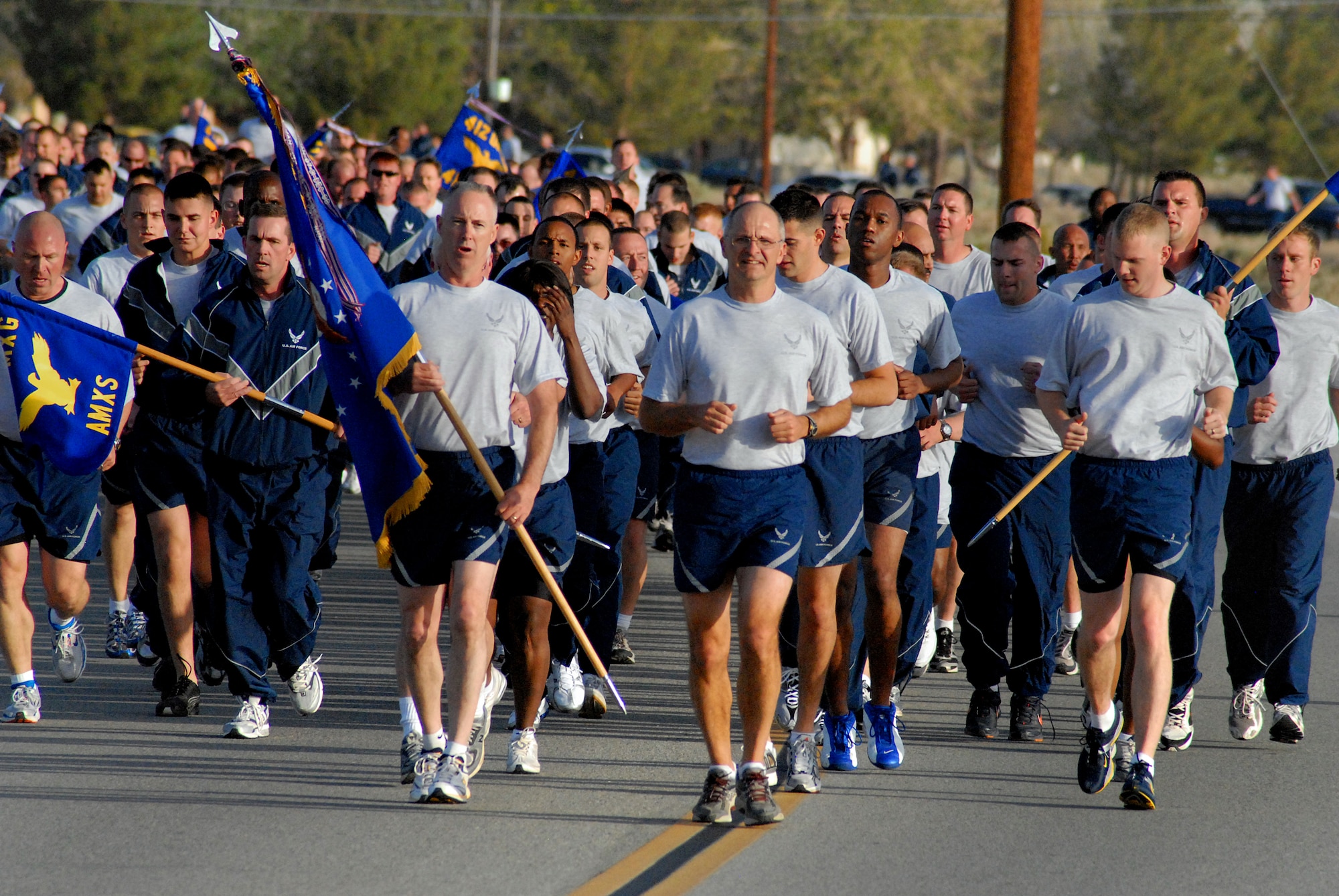EDWARDS AIR FORCE BASE, Calif. -- Col. Arnie Bunch (foreground, right) and Chief Master Sgt. Kevin Soltis (foreground, left), 412th Test Wing commander and command chief master sergeant, lead Airmen from the 412th Test Wing on a 1.5-mile fitness run here May 9. More than 700 Airmen from the Air Force Flight Test Center here participated in the fitness run to promote fitness and esprit de corps. (Air Force photo by Master Sgt. Eric M. Grill)