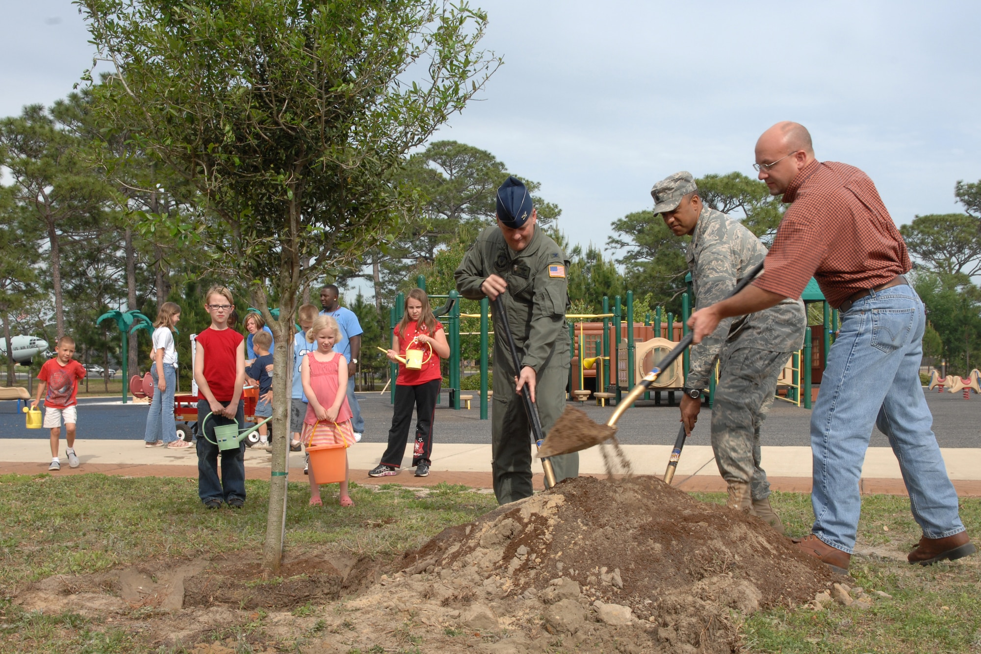 Col. Marshall Webb, 1st Special Operations Wing commander, (left) with Lt. Col. Michael Hammond, 1st Special Operations Communications Squadron commander, and Mr. Philip Pruitt, 1st Special Operations Civil Engineer Squadron, (right) plant a tree April 24, 2008, in Hurlburt Field's community park for Arbor Day. Arbor Day is a holiday in which individuals and groups are encouraged to plant and care for trees. (U.S. Air Force photo by Airman 1st Class Kimberly Darnall)