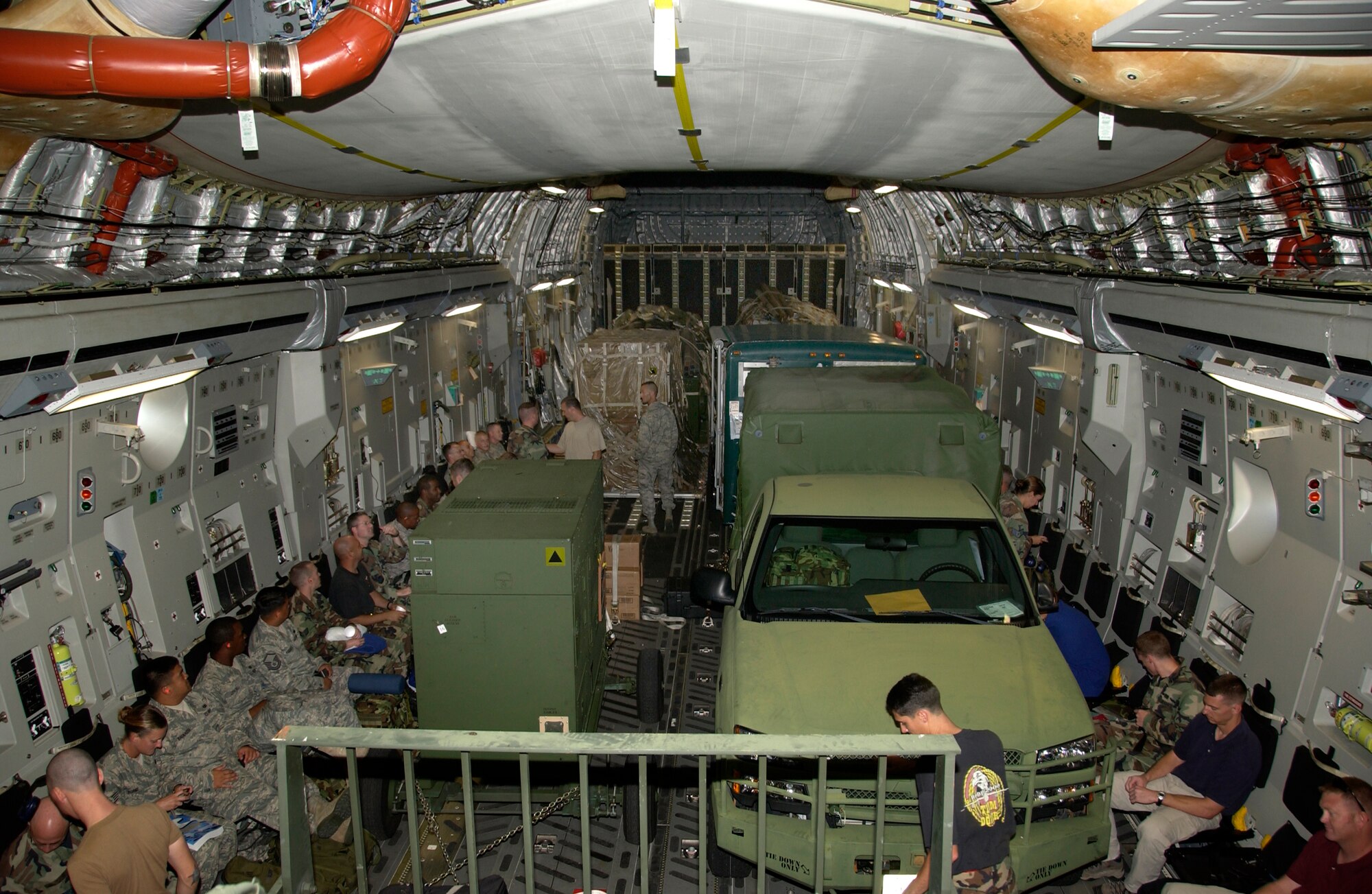 ANDERSEN AFB,GUAM -- Just under 50 members of the 36th Contingency Response Group settled into their seats in a crowded cargo section of the C-17 Globemaster III aircraft.  The personnel and equipment are heading to Thailand to stand ready to provide humanitarian aid to the people of Burma (Myanmar).  Units of all branches of the military are standing by, for an offical request from the Burma (Myanmar) government, to render aid to a country and people ravaged by massive flooding from
 Cyclone Nargis. (US Air Force Photo by Tech. Sgt. Michael Boquette)