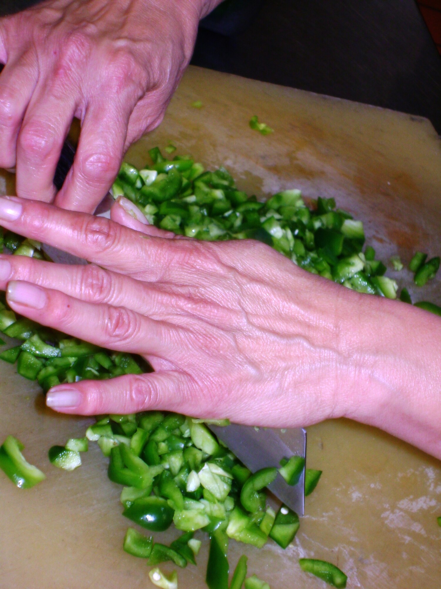 ANDREWS AIR FORCE BASE, Md. -- Bernice Sullivan, 1st Cook at the Liberty Hall Dining Facility chops green peppers, in preperation for lunch. The dining facility is scheduled for closure May 30. (U.S. Air Force photo/Tech. Sgt. Eric Sharman)