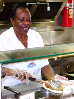 ANDREWS AIR FORCE BASE, Md. -- Mary Gilbert, 2nd Line Cook at the Liberty Hall Dining Facility here, scoops peas onto a plate. The dining facility is scheduled for closure May 30. (U.S. Air Force photo/Tech. Sgt. Eric Sharman)