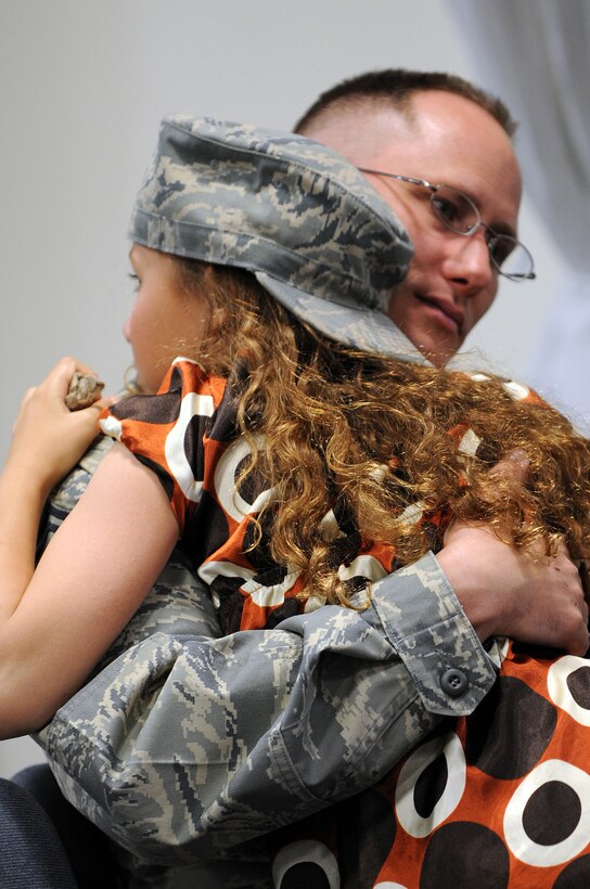 Senior Master Sgt. Richard Johnson, 28th Logistics Readiness Squadron material management flight chief, hugs his daughter, Halle, before leaving for a deployment here, May 9. Ten members of the 28 LRS deployed to the 379th Air Expeditionary Wing in Southwest Asia in support of Operation Iraqi Freedom and Operation Enduring Freedom. (U.S. Air Force photo/Senior Airman Marc I. Lane)