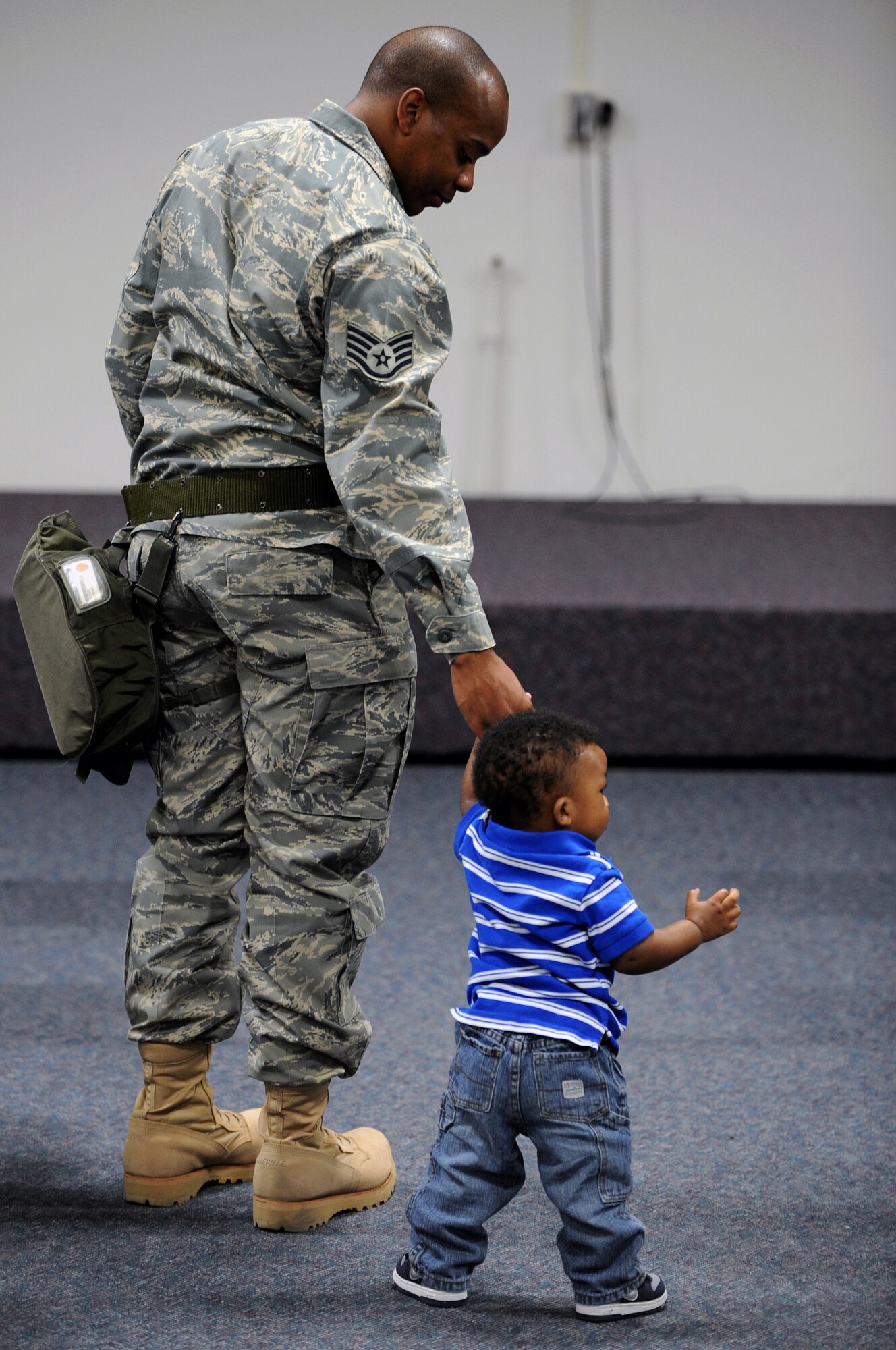 Staff Sgt. James Thomason, 28th Logistics Readiness Squadron supply supervisor, spends time with his 1-year-old son, Jayden, before leaving for a deployment out here, May 9. Ten members of the 28 LRS deployed to the 379th Air Expeditionary Wing in Southwest Asia in support of Operation Iraqi Freedom and Operation Enduring Freedom. (U.S. Air Force photo/Senior Airman Marc I. Lane) 