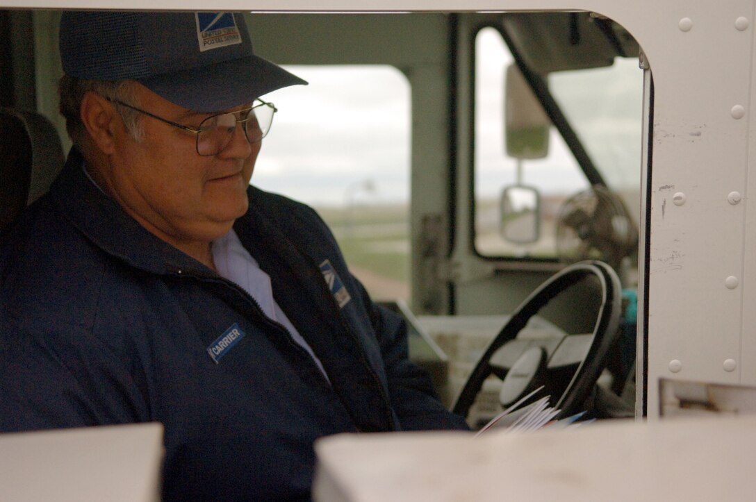 Craig Fountain, United States Postal Service city carrier, delivers mail to Ellsworth residents May 9. Employees of USPS handle more than 44 percent of the world's mail volume — delivering more mail to more addresses and to a larger geographic area than any other postal administration in the world. May 12 the price of that service will change.