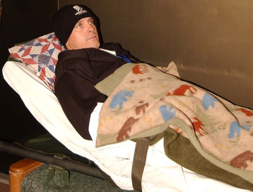 ANDREWS AIR FORCE BASE, Md. -- Private First Class Kenneth Adkins lies on a litter waiting to be loaded onto an ambus and taken to the flightline to be loaded on a C-130 aircraft headed home to Ft. Campbell, Ky. (U.S. Air Force photo/Master Sgt. Shayne Sewell) 