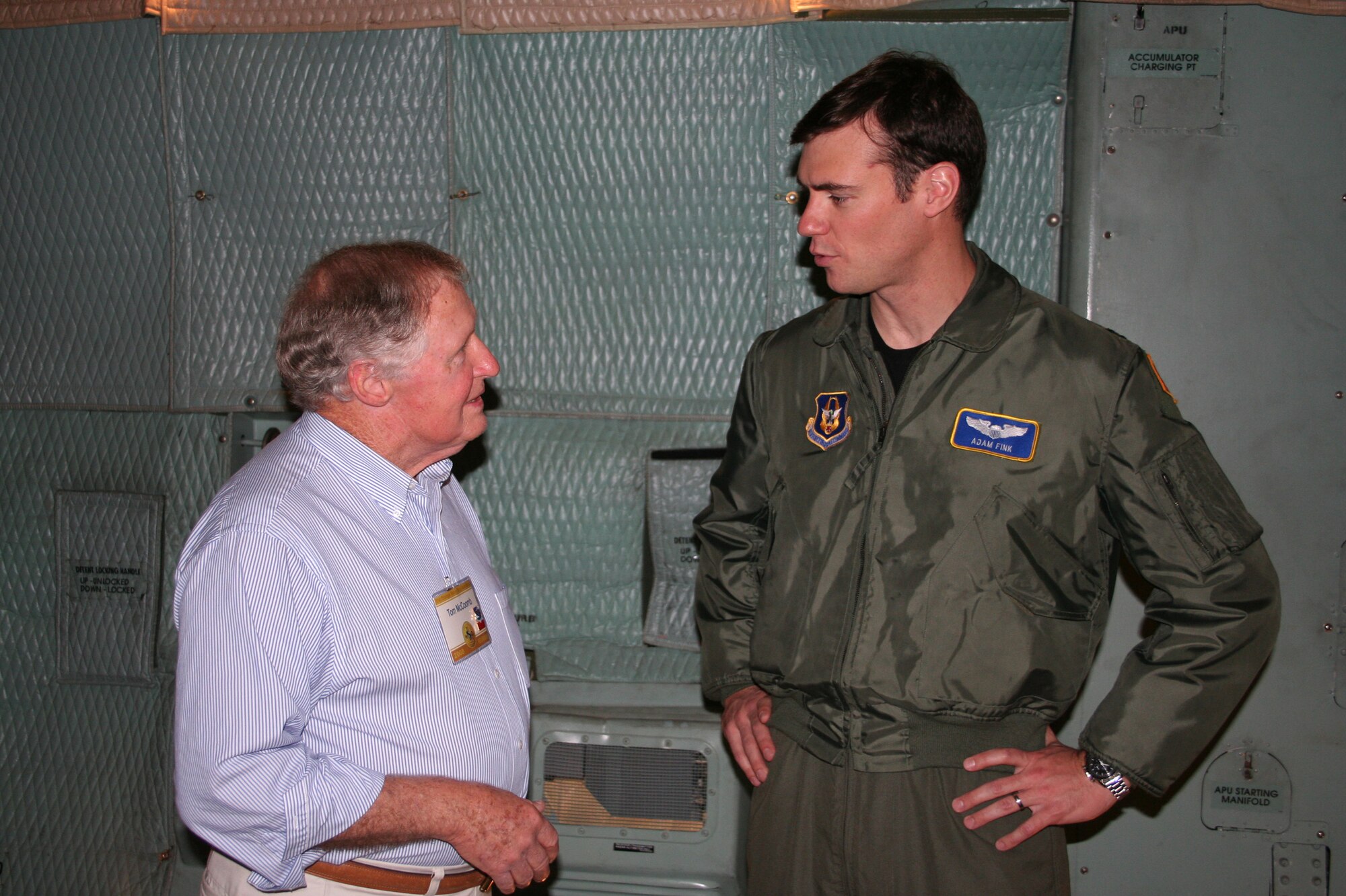 WRIGHT-PATTERSON AFB, Ohio - Capt. Adam Fink, 89th Airlift Squadron, talks with Mr. Tom McCoomb, a member of the 91st Strategic Reconnaissance Wing Association during a tour of the 445th Airlift Wing and C-5 Galaxy. Association members, which include former pilots, maintainers, and crewmembers, had their annual reunion over the weekend. (U.S. Air Force photo/ Maj. David Borchardt)  