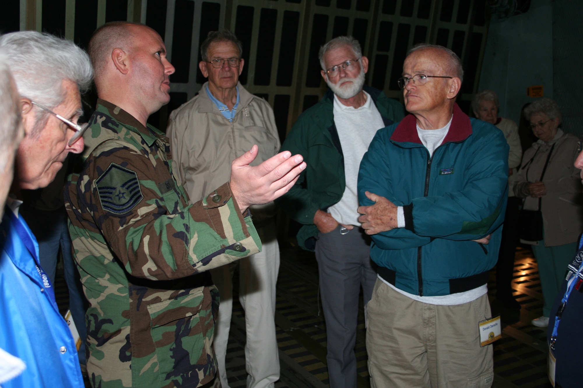 WRIGHT-PATTERSON AFB, Ohio - Master Sgt. Jon Brown, 89th Airlift Squadron, talks with members of the 91st Strategic Reconnaissance Wing Association during a tour of the 445th Airlift Wing and C-5 Galaxy. Association members, which include former pilots, maintainers, and crewmembers, had their annual reunion over the weekend. (U.S. Air Force photo/ Maj. David Borchardt)  