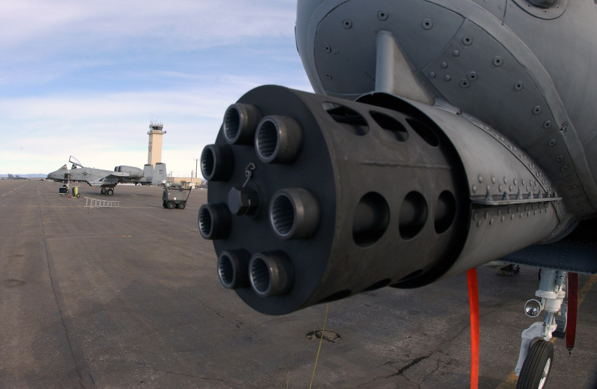 Two A-10 Thunderbolt IIs from the 355th Fighter Squadron at Eielson Air Force Base, Alaska, sit on the flightline awaiting the next mission. On the nose of the A-10 is a 30mm GAU-8 Avenger seven-barrel Gatling gun which is used to pierce heavy armor.  (U.S. Air Force photo/Senior Airman Joshua Strang)