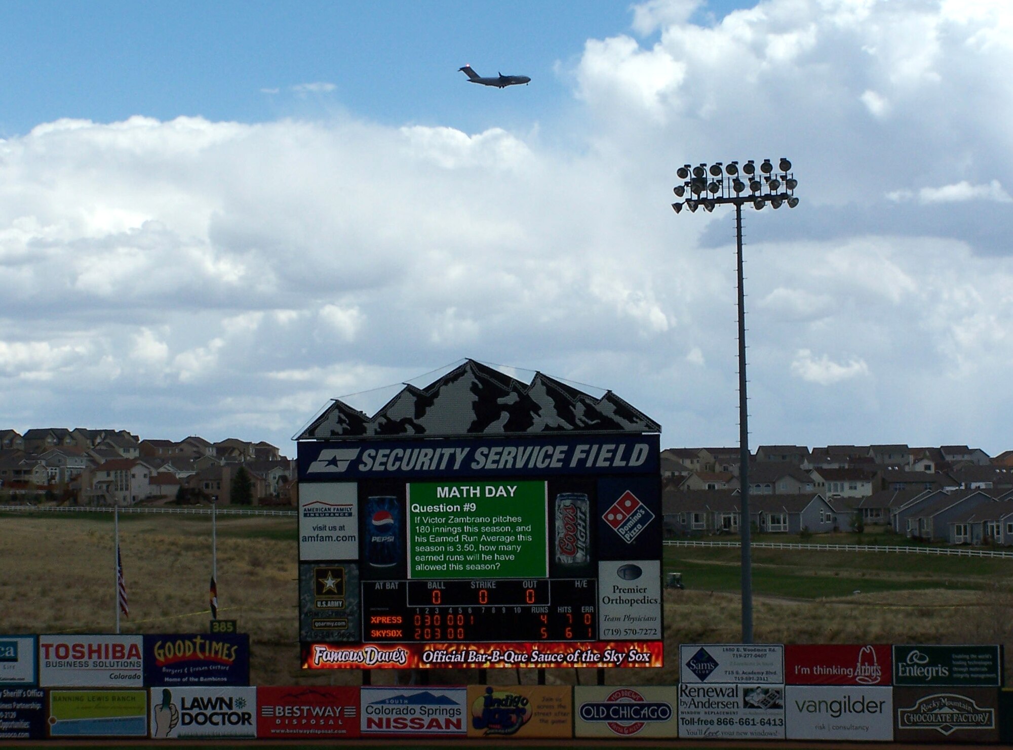 A C-17 Globemaster III flies by Security Service Field before a local baseball game May 8 in Colorado Springs, Colo. The aircraft was landing while Guardian Challenge team members descended upon the stadium as the teams prepared for three days of GC events, including a golf tournament, space and missile forum and awards and dinner banquet May 9. The Guardian Challenge competition pits the command’s several space wings against each other to see who’s the “best of the best” in areas of expertise, including security forces, communications, missile combat or satellite operations. (U.S. Air Force photo/Master Sgt. Matt Gilreath)