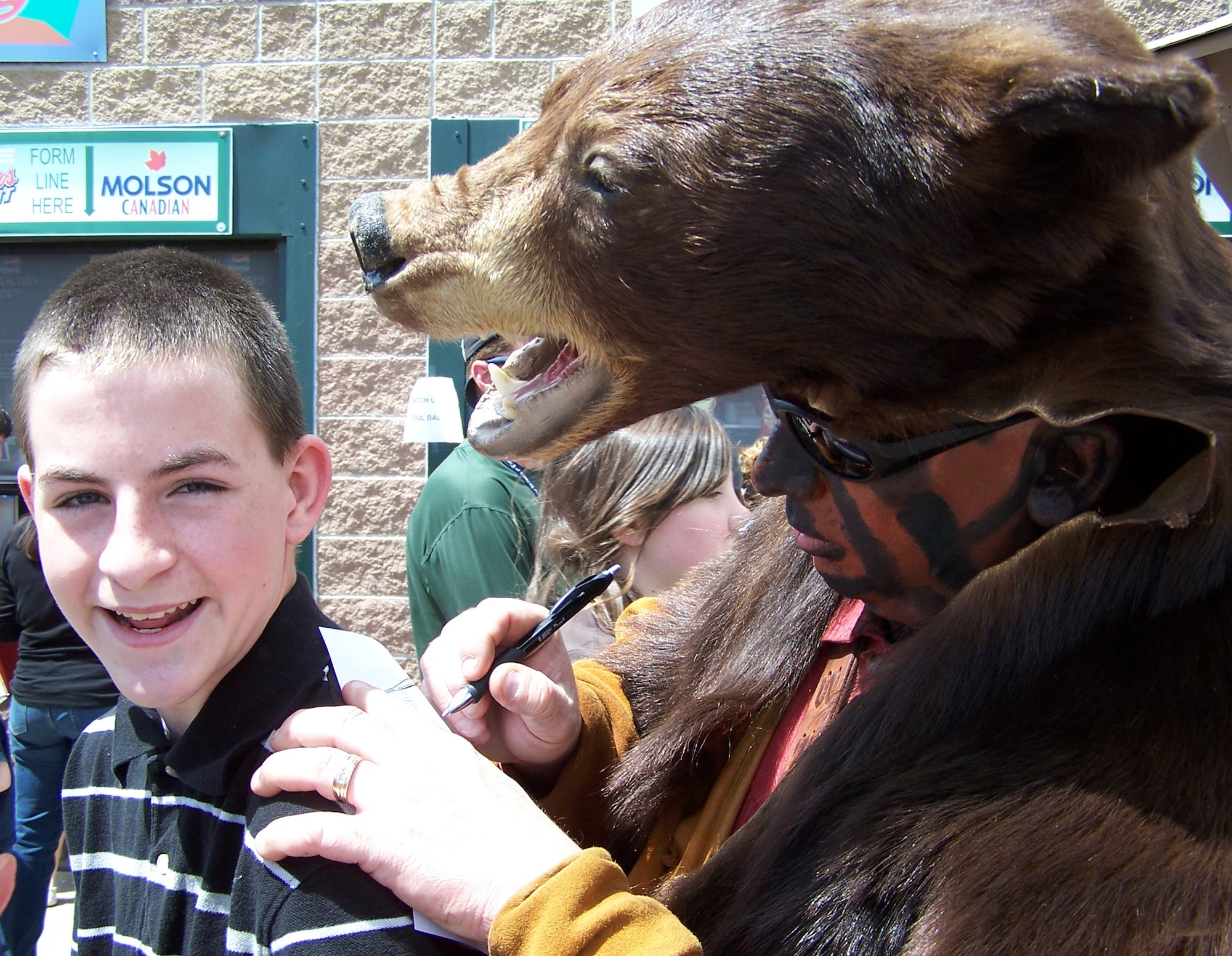 Grizz, mascot for the 341st Space Wing, based at Malmstrom Air Force Base, Mont., signs autographs for local fans at Security Service Field during a baseball game May 8 in Colorado Springs, Colo. Guardian Challenge team members descended upon the stadium as the teams prepared for three days of GC events, including a golf tournament, space and missile forum and awards and dinner banquet May 9. The Guardian Challenge competition pits the command’s several space wings against each other to see who’s the “best of the best” in areas of expertise, including security forces, communications, missile combat or satellite operations. (U.S. Air Force photo/Master Sgt. Matt Gilreath)