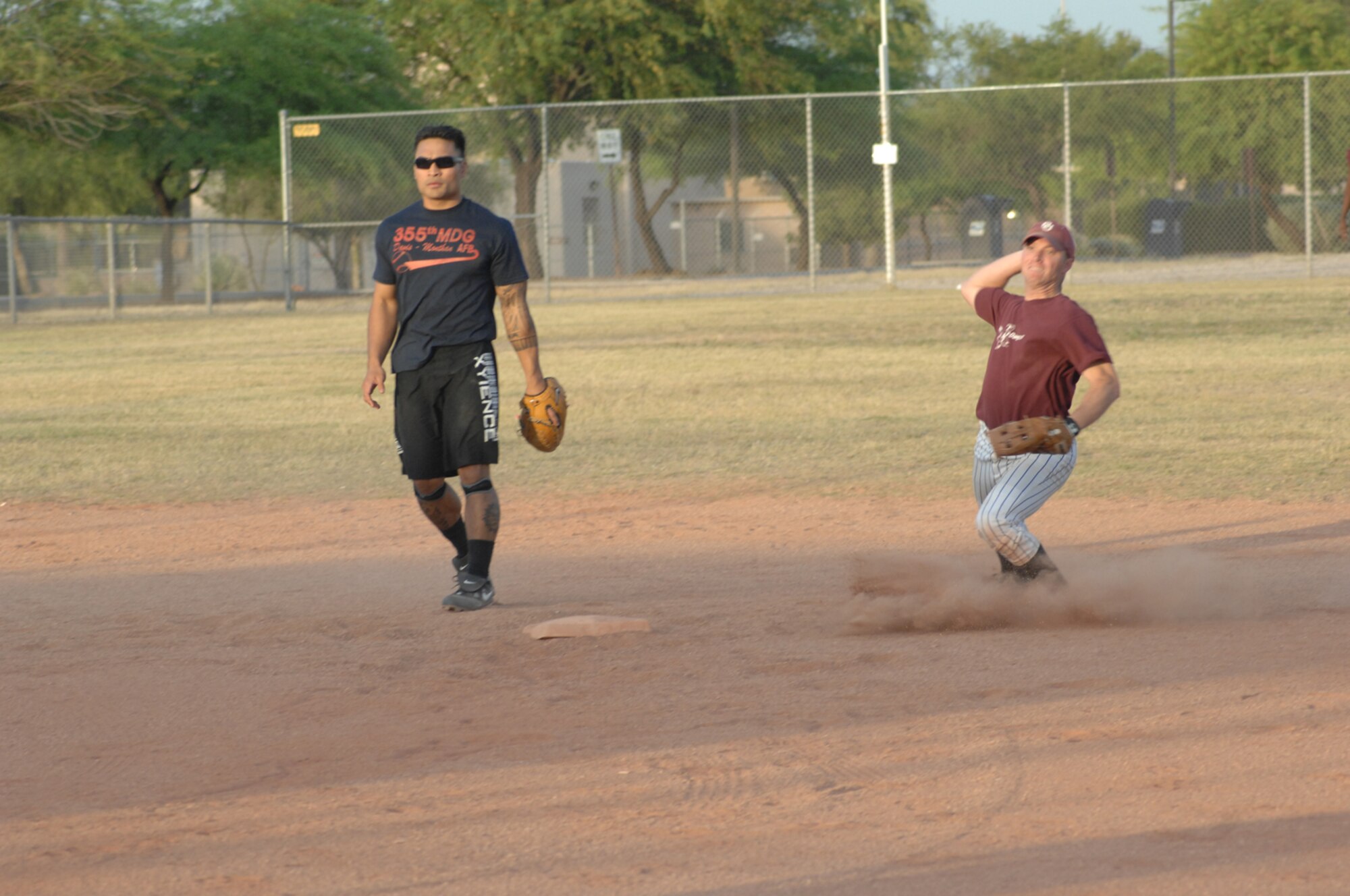 The Med Group's second baseman throws out a member of OWS in a 33-10 Med Group victory of a D-M intramural softball leage game May 8. (U.S. Air Force photo by Senior Airman Alesia Goosic)