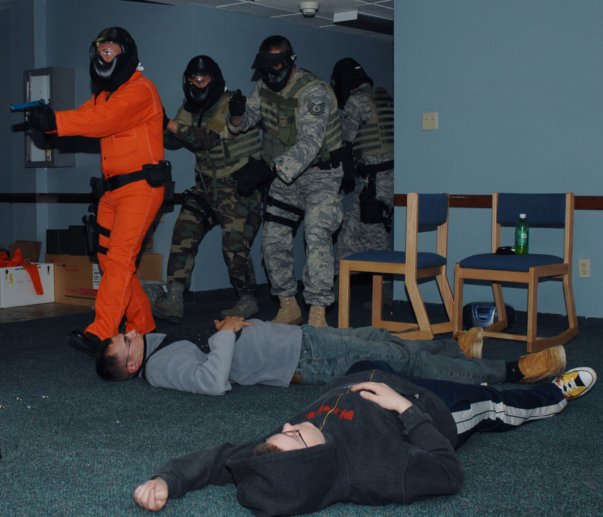 CANNON AIR FORCE BASE, N.M. - "Casualties", volunteers from base, lay on the floor of Building 1160, a vacated dormitory, distracting law enforcement agents to test their response during a mock critical hostage situation May 7.  The first four-man team went forward to neutralize the threat as the second team (pictured) evacuated the injured. (U.S. Air Force photo/Airman 1st Class James R. Bell)