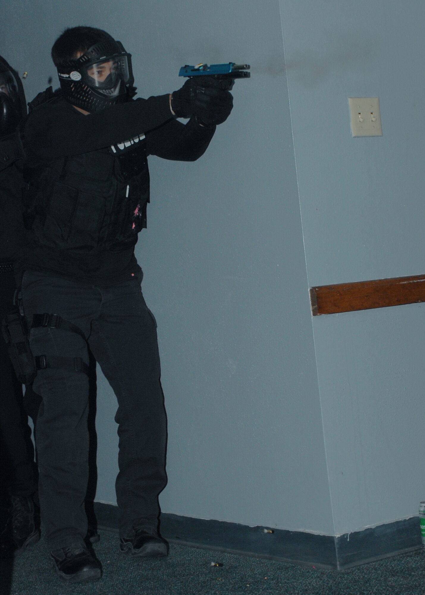 CANNON AIR FORCE BASE, N.M. - A local police officer fires a simunition round toward an active shooter during a training course in Building 1160 May 7.  The three-day "Patrol Response to Active Shooter" course is taught by the National Tactical Officers Association. (U.S. Air Force photo/Airman 1st Class James R. Bell)