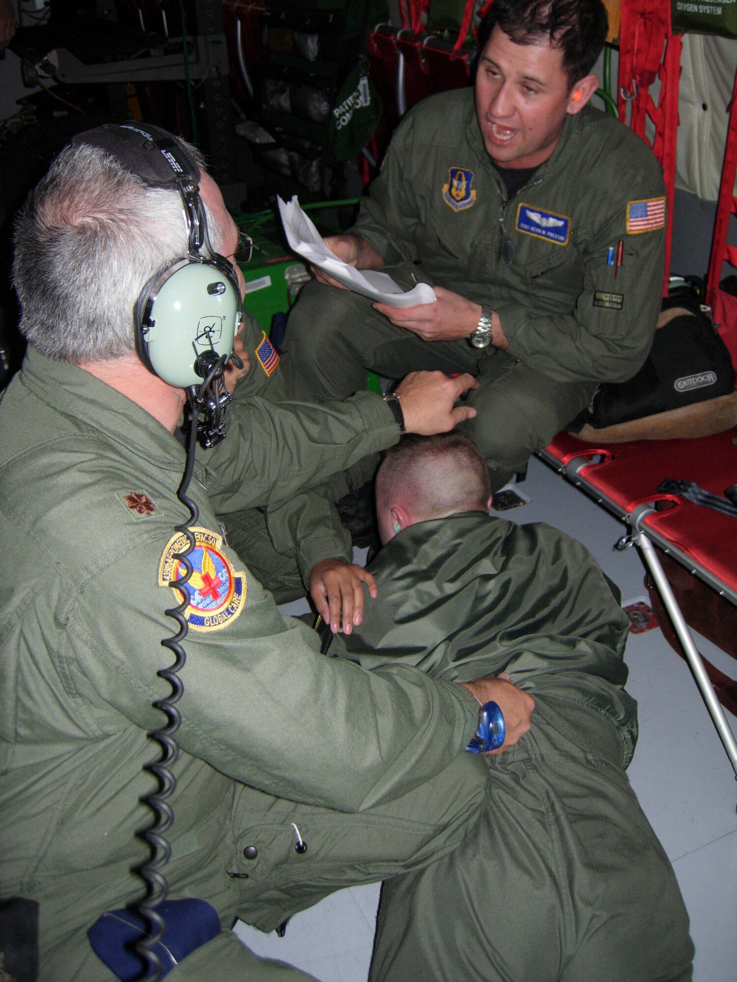 ST. CROIX, U.S. VIRGIN ISLANDS -- Maj. Bryan Castle, 439th Aeromedical Evacuation Squadron flight nurse, simulates subduing Senior Airman Carl Stewart II, 459th Aeromedical Evacuation Squadron medical technician, as Staff Sgt. Kevin Preston calls out procedures during an in-flight exercise. Airman Stewart simulated a mentally impaired passenger who attempted to open cabin doors during the flight. Ten members of the 439th AES joined more than a dozen 459th AES members in a blended AE training mission to the island. Mission training expanded beyond the medical realm to include air refueling and an overseas sortie. (U.S. Air Force photo/Staff Sgt. Amaani Lyle)