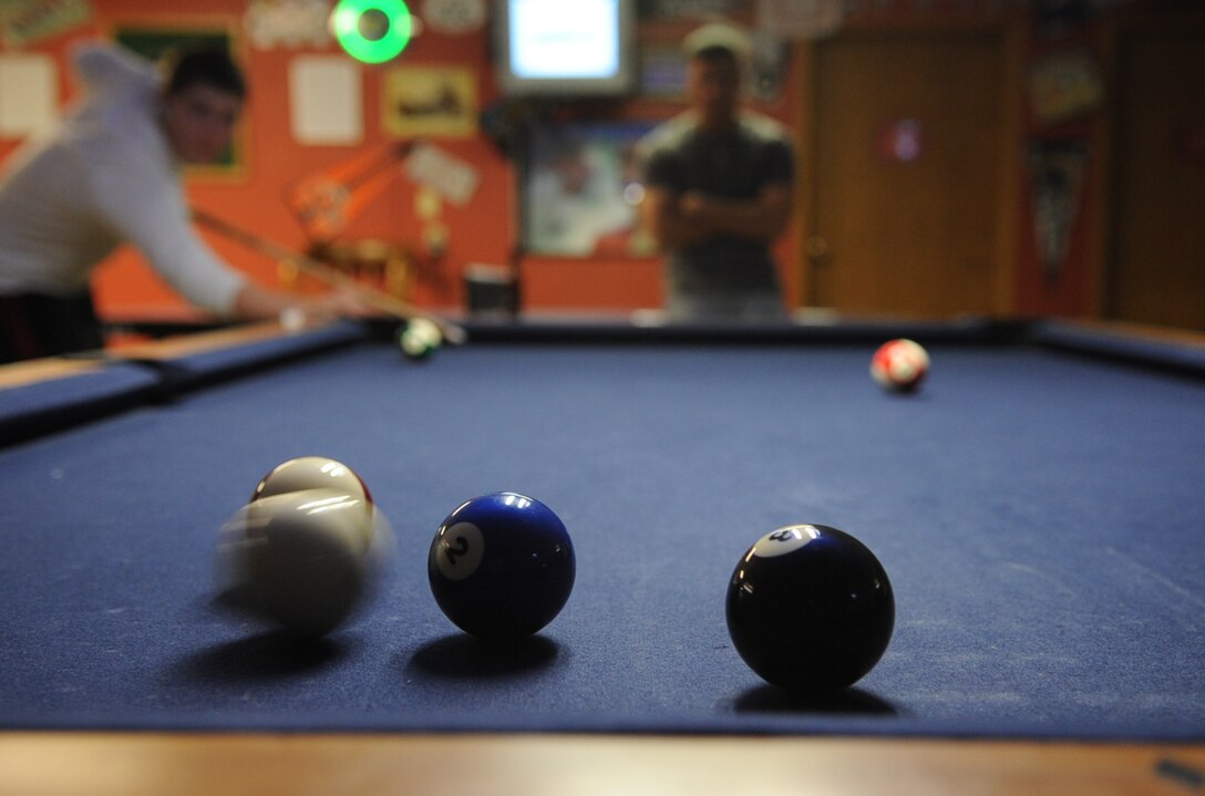 Airman Scott Ross, 28th Medical Group aerospace medical technician, shoots a bank shot, but misses his target during the first Airmen Billiards Tournament at the Black Hills Community Center, May 7.  The tournament began May 7 and will run through June 25; finals begin June 28. (U.S. Air Force photo/Senior Airman Anthony Sanchelli)
