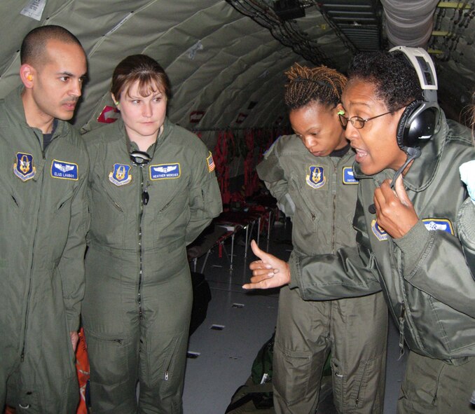 ST. CROIX, U.S. VIRGIN ISLANDS -- (Right) Lt. Col. Vanessa Mattox, 459th Aeromedical Evacuation Squadron commander, explains training procedures to Capt. Eliud Lamboy, Maj. Heather Menzies and Senior Master Sgt. P.J. Pierce during an in-flight exercise April 18. Ten members of the 439th AES joined more than a dozen 459th AES members in a blended AE training mission to the island. Mission training expanded beyond the medical realm to include air refueling and an overseas sortie. Captain Lamboy and Major Menzies are 459th AES flight nurses and Sergeant Pierce is a 459th AES medical technician. (U.S. Air Force photo/Staff Sgt. Amaani Lyle)