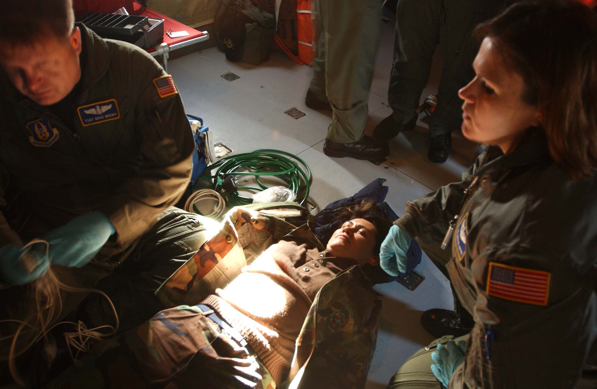 ST. CROIX, U.S. VIRGIN ISLANDS -- Tech. Sgts. Grae Brown and Crystal Drake, 459th Aeromedical Evacuation Squadron medical technicians, administer care to simulated patient Master Sgt. Patty Guzman-Evans, 459th AES first sergeant, during an in-flight exercise. Ten members of the 439th AES joined 459th AES members in a blended AE training mission to the island. Mission training expanded beyond the medical realm to include air refueling and an overseas sortie. (U.S. Air Force photo/Staff Sgt. Amaani Lyle)