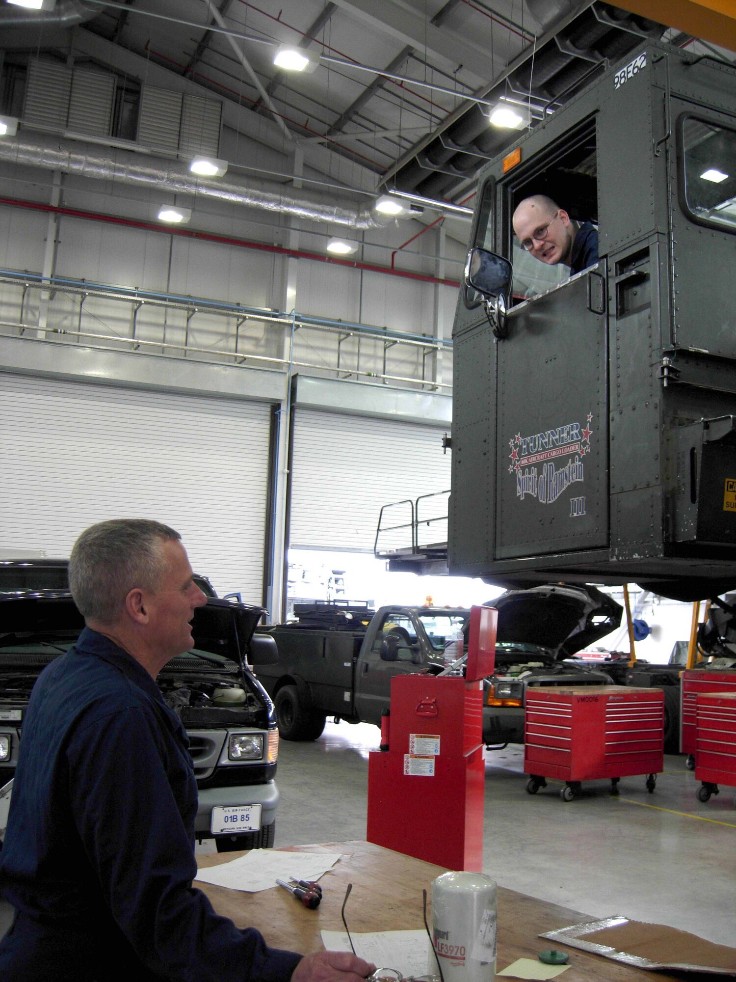 RAF MILDENHALL, England -- Master Sgt. Steve Bedell, 459th Logistics Readiness Squadron vehicle and equipment maintenance craftsman, signals to Airman 1st Class Alexander Bissius, 100th Logistics Readiness Squadron vehicle maintenance journeyman, to raise a a 60K loader to check for hydraulic and electrical deficiencies April 14. Thirty-one members of the 459th Logistics Readiness Flight, 459th Communications Flight, 459th Mission Support Group and the 69th Aerial Port Squadron spent their annual tour here to support U.S. Air Forces in Europe taskings for the rural area mission, about 80 miles outside of London. (U.S. Air Force photo/Staff Sgt. Amaani Lyle)