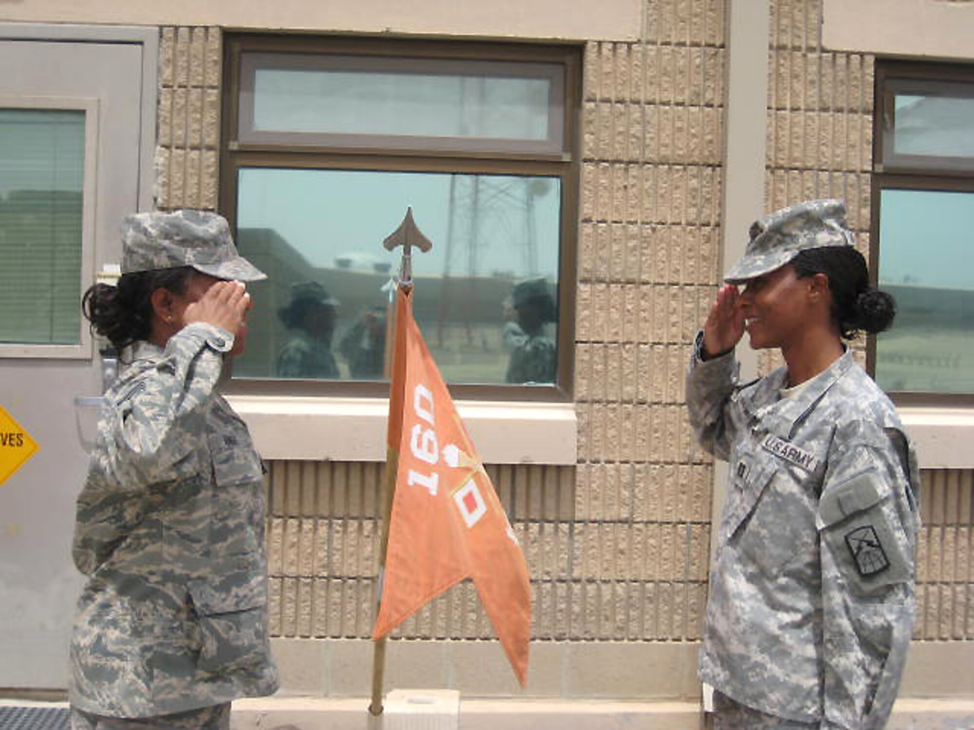 SOUTHWEST ASIA -- Chief Master Sgt. Sadie Knight renders a salute to her daughter, Army Capt. Stacy Mitchell from the Army's 160th Signal Brigade, before departing the Army camp in the Persian Gulf Region April 10, 2008.  Chief Knight and Captain Mitchell were assigned to different locations in the region, but were able to meet four times during their time in the area of operation while supporting the Global War on Terror. (U.S. Army courtesy photo)