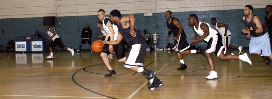 Hakim Tutt, 512th MSS coach, sprints and dribbles down the court to beat the Maintainers to the basket with a lay-up. (U.S. Air Force photos/Airman 1st Class Shen-Chia Chu)