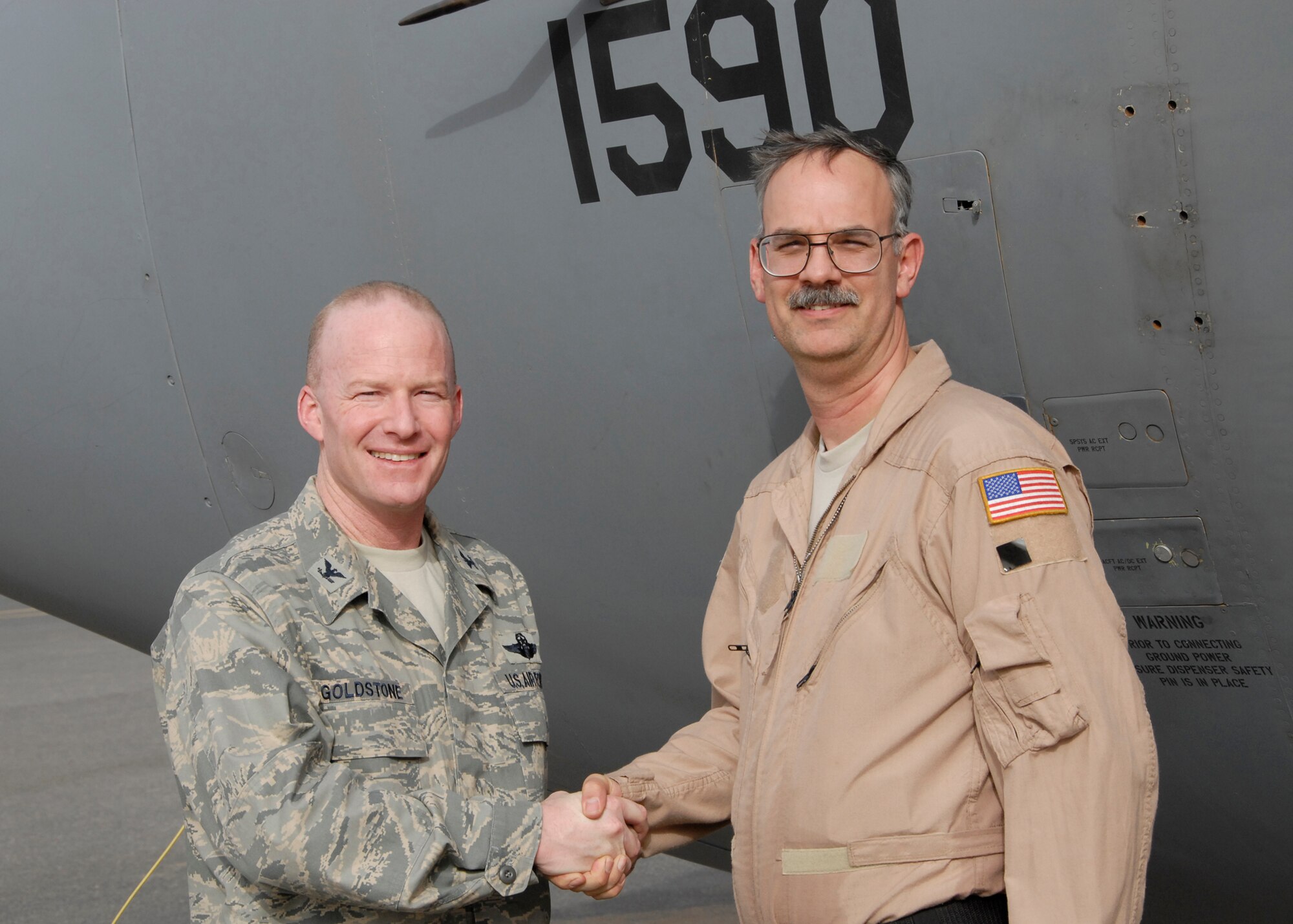 SOUTHWEST ASIA -- Colonel Gary Goldstone, 386th Expeditionary Operations Group commander, congratulates Master Sgt. Anthony Acciani at an air base in the Persian Gulf Region, following the completion of his 1,000th sortie which took place while flying over Iraq May 7, 2008. Sergeant Acciani is a flight engineer deployed with the 43rd Expeditionary Electronic Combat Squadron supporting the Global War on Terrorism. Sergeant Acciani is deployed from Davis-Monthan Air Force Base, Ariz. (U.S. Air Force photo/Capt. Jason McCree)