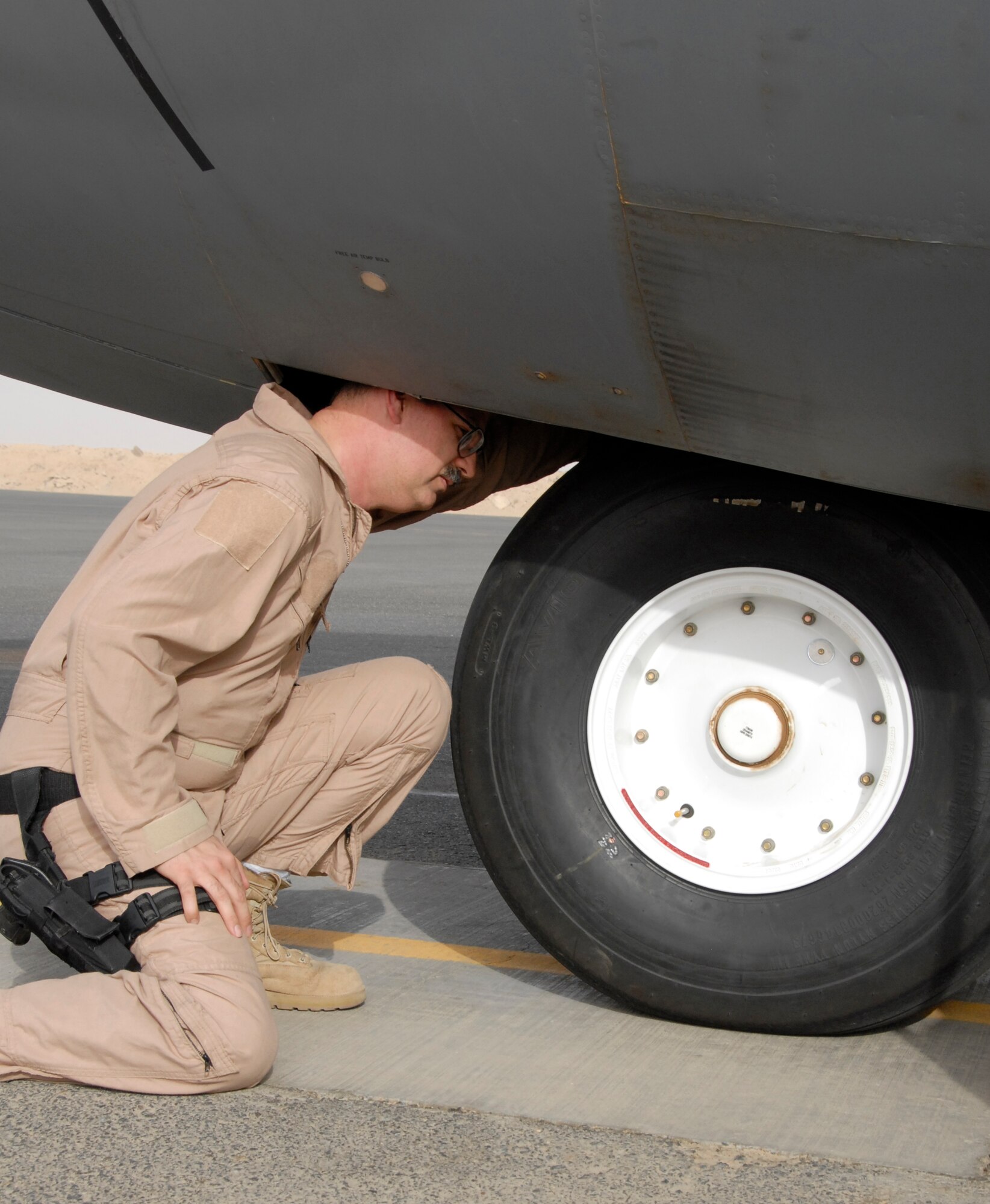 SOUTHWEST ASIA -- Master Sgt. Anthony Acciani, a flight engineer with the 43rd Expeditionary Electronic Combat Squadron, inspects an EC-130H Compass Call after flying his 1000th sortie May 7, 2008, over the skies of Iraq. Sergeant Acciani's sortie milestone is capped off with more than 200 of them being combat sorties and is deployed from Davis-Monthan Air Force Base, Ariz. (U.S. Air Force photo/Capt. Jason McCree)