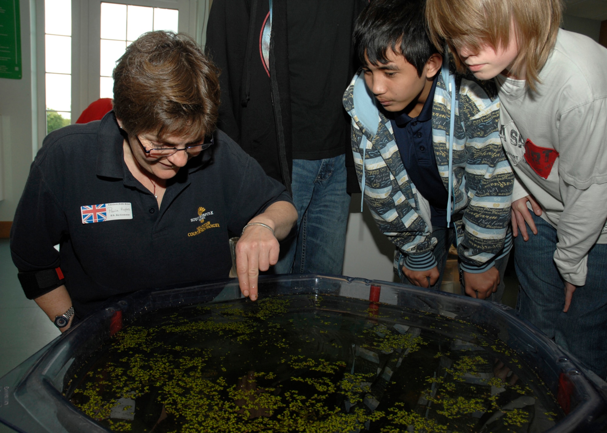 Paula Hughes, Volunteer Countryside Ranger for South Norfolk Council, teaches Lakenheath Middle School students about pond life May 2 on RAF Feltwell. More than 100 residents of the local community participated in the event to educate children on U.K. customs, history and heritage and to foster a relationship with the host nation. (U.S. Air Force photo by Airman 1st Class John Easterling)