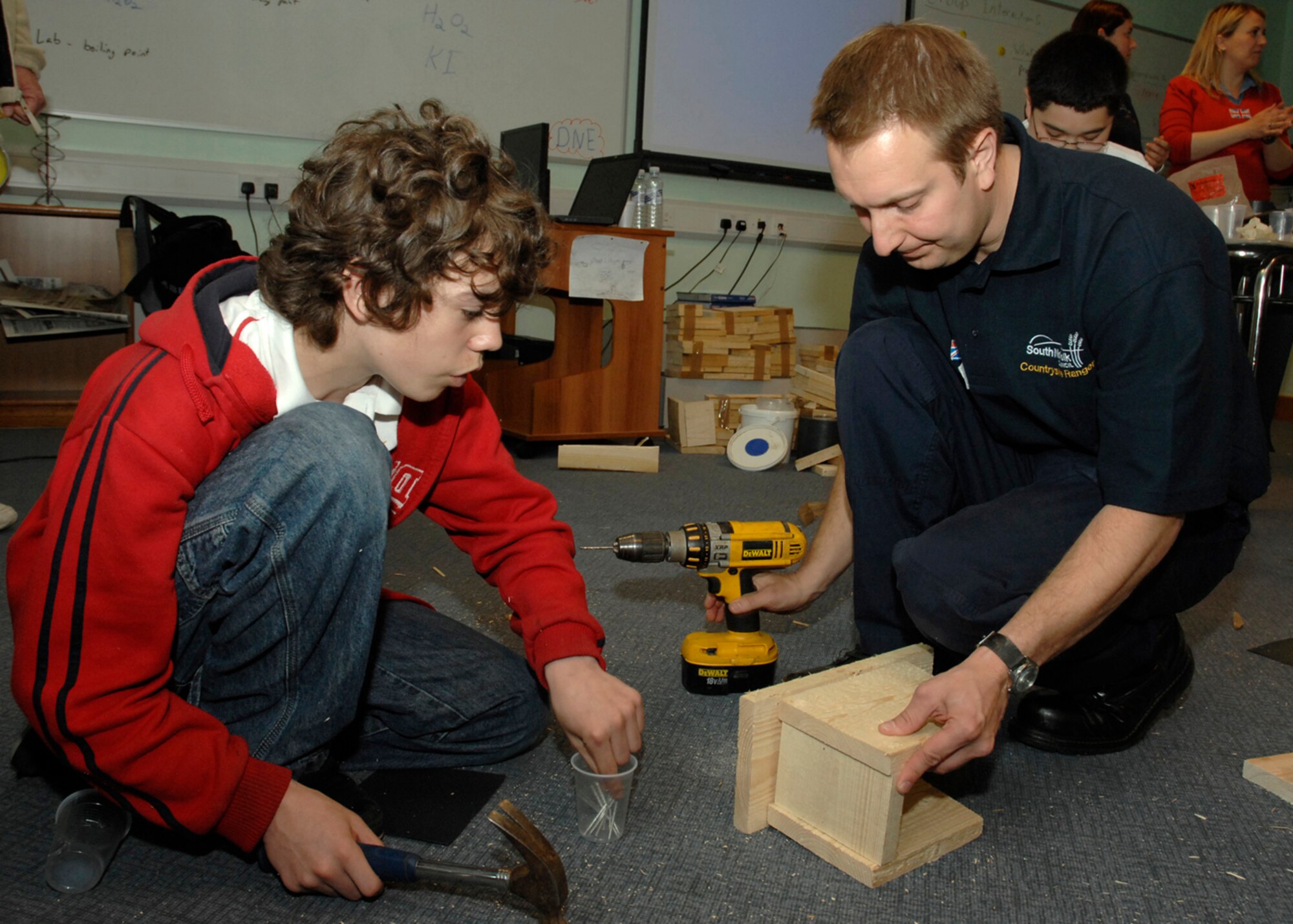 Justin Green builds a bird box with John Cook, Countryside Ranger for South Norfolk Council during Lakenheath Middle School’s U.K. Day, May 2 on RAF Feltwell. More than 100 residents of the local community participated in the event to educate children on U.K. customs, history and heritage and to foster a relationship with the host nation. (U.S. Air Force photo by Airman 1st Class John Easterling)