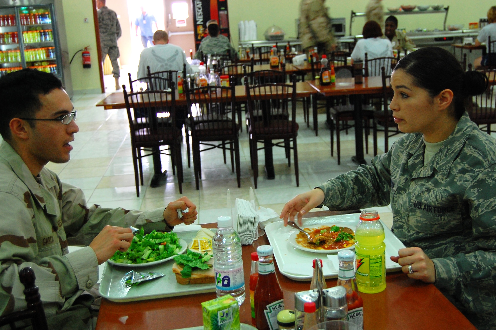 SOUTHWEST ASIA -- Senior Airman Christina Stimpson, a financial management specialist, and cousin Navy HN Anthony Garcia, a hospital corpsman, spent the afternoon together Feb. 11 reminiscing about the past and catching up on each other's military careers. Both were deployed to the same region of Southwest Asia for three weeks supporting the Global War on Terror before he wrapped up his deployment and returned to Naval Air Station Patuxent River, Md. Airman Stimpson is deployed from Robins Air Force Base, Ga. (U.S. Air Force photo/Staff Sgt. Patrick Dixon)