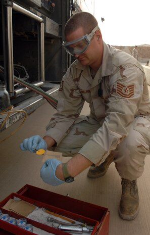 KIRKUK REGIONAL AIR BASE, Iraq – Tech Sgt. Joe Maurin, 506th Expeditionary Logistics Readiness Squadron, performs a color particle and water assessment on a refueling vehicle here recently. Sergeant Maurin is deployed here from Charleston Air Force Base, S.C., and is a native of Wasilla, Ala. (U.S. Air Force photo by Senior Airman SerMae Lampkin)