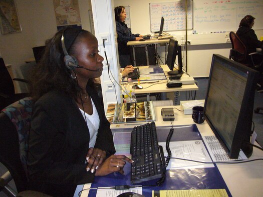 Lucy Katana, USAFE Consolidated Switchboard operator, answers calls May 6 on Ramstein. Ms. Katana is originally from Uganda and she speaks five languages. She likes her job because she is able to provide customer care and talk to different people around the world. (Photo by Capt. Erin Dorrance)  

