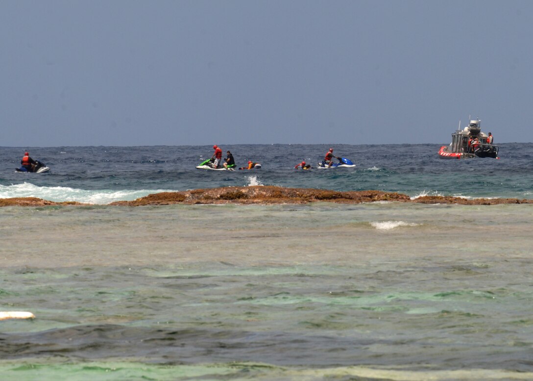 The U.S. Coast Guard and the Andersen AFB Fire Department simulate water search and rescue during the SAREX May 8 at Tarague Beach. The exercise enhances the tactical inter-operability within the island of Guam for water rescue emergencies in realistic ocean environment. The SAREX also included members from Guam's police and fire departments, the Navy's Helicopter Sea Combat Squadron 25, Coast Guard, Jeff's Pirates Cove Rescue Team. (U.S. Air Force photo by Airman 1st Class Nichelle Griffiths)