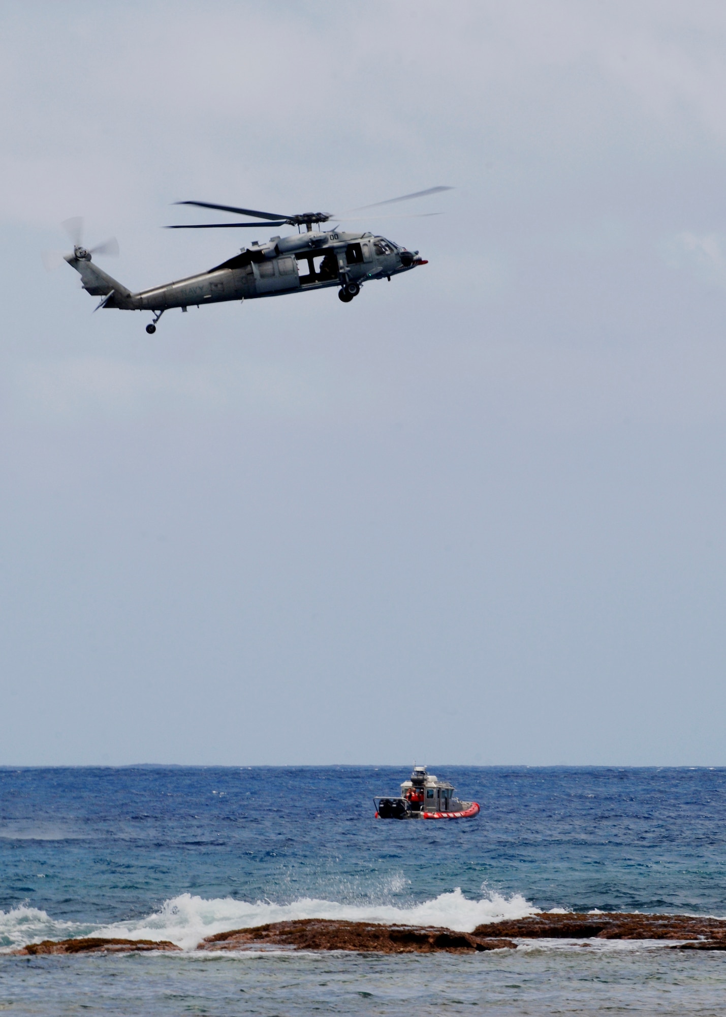 U.S. Navy Helicopter Sea Combat Squadron 25 a tenant unit out of Andersen Air Force Base and the U.S. Coast Guard participate in the water search and rescue exercise May 8 at Tarague Beach. The exercise enhances the tactical inter-operability within the island of Guam for water rescue emergencies in realistic ocean environment. The SAREX also included members from Guam's police and fire departments, the Navy's Helicopter Sea Combat Squadron 25, Coast Guard, Jeff's Pirates Cove Rescue Team. (U.S. Air Force photo by Airman 1st Class Nichelle Griffiths)