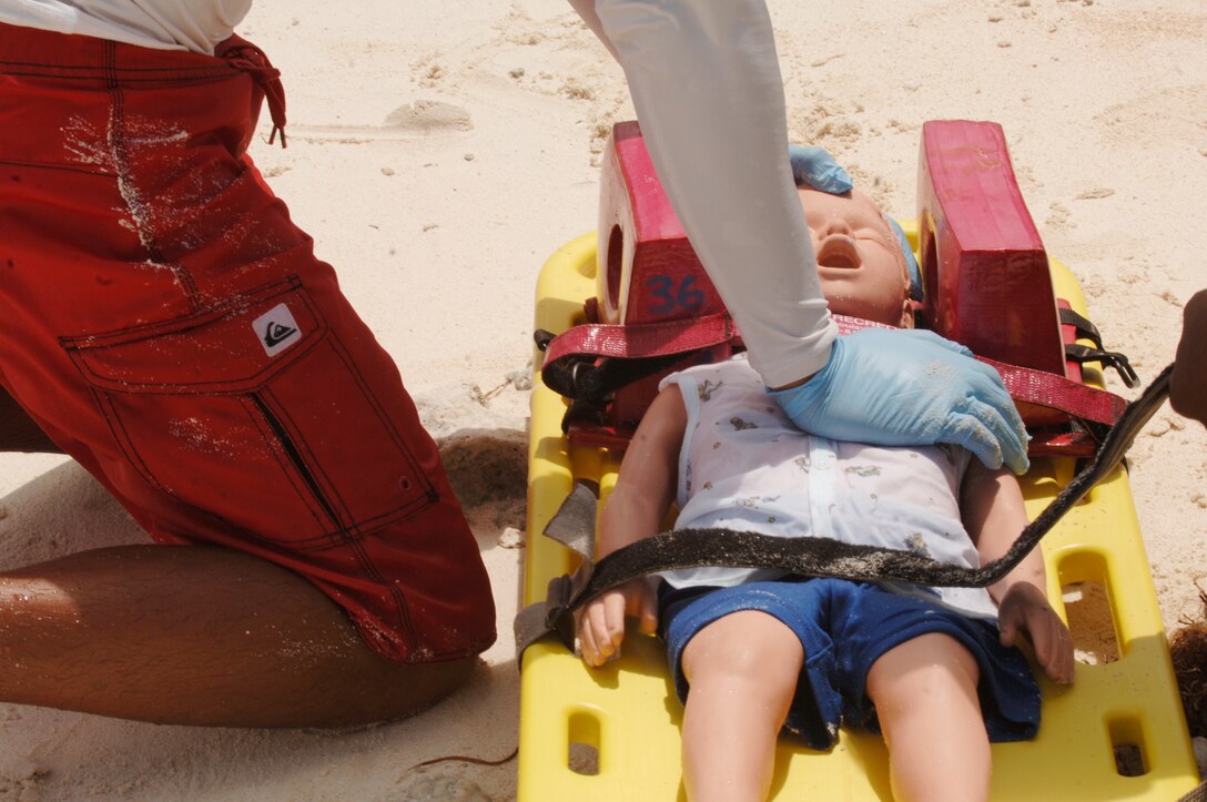 Andersen Air Force Base lifeguard Ruben Cruz simulates CPR on a child during the water search and rescue exercise on May 8 at Tarague Beach. The exercise enhances the tactical inter-operability within the island of Guam for water rescue emergencies in realistic ocean environment. The SAREX also included members from Guam's police and fire departments, the Navy's Helicopter Sea Combat Squadron 25, Coast Guard, Jeff's Pirates Cove Rescue Team.  (U.S. Air Force photo by Airman 1st Class Nichelle Griffiths)