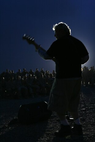 Bassist Mark Ferry of The Saloonatics, rocks out in front of Marines of 2nd Battalion, 3rd Marine Regiment, Regimental Combat Team 1, at Camp Fallujah, Iraq, May 9, as part of mini-tour for service members deployed. The Marines got into the show by singing along and jumping around with the band as they played classic songs from the 70's, 80's, 90's and todays music.