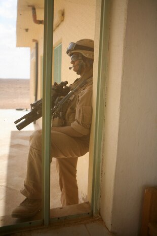 Lance Cpl. Brandon J. Frazer, 21, a scout from Kissame, Fla., with Team Mustang, 2nd Light Armored Reconnaissance Battalion, Regimental Combat Team 5, provides security during a meeting with Iraqi citizens while patrolling along Route Mobile of western Al Anbar province, Iraq, May 8. The Marines took time to visit citizens along Route Mobile to ensure insurgents weren't in the area to cause damage or harm the residents or Coalition forces.