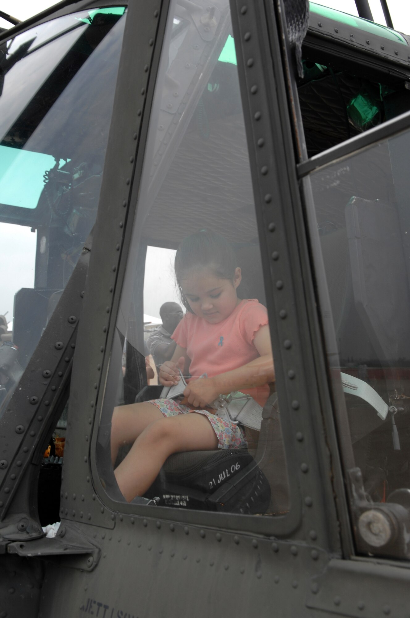 BARKSDALE AIR FORCE BASE, La. -- Zoe Garcia, 5, straps on the pilots safety harness in a U.S. Air Force UH-1 Huey helicopter on the flight line of Barksdale Air Force Base, La. during the 2008 Defenders of Liberty Air Show.  The Air Show commemorates the 75th anniversary of Barksdale Air Force Base.  (U.S. Air Force photo by TSgt Laura K. Smith)