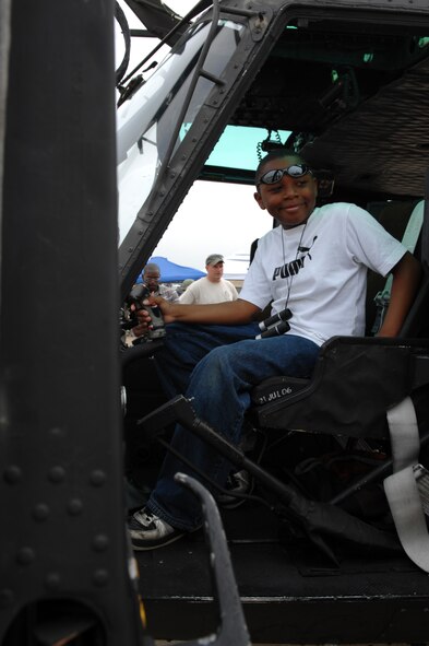 BARKSDALE AIR FORCE BASE, La. -- Justin Jackson,9, sits in the cockpit of a U.S. Air Force UH-1 Huey helicopter on the flight line of Barksdale Air Force Base, La. during the 2008 Defenders of Liberty Air Show.  The Air Show commemorates the 75th anniversary of Barksdale Air Force Base.  (U.S. Air Force photo by TSgt Laura K. Smith)
