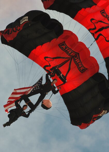 U.S. Army Black Daggers float high above Air Show crowds with our nation's flag at Barksdale Air Force Base, Louisiana, on April 21, 2007. This event marked the beginning of the Defender's of Liberty Air Show 2007 while some of Barksdale's Officers sung the National Anthem. (U.S. Air Force photo by Airman 1st Class Joanna M. Kresge)