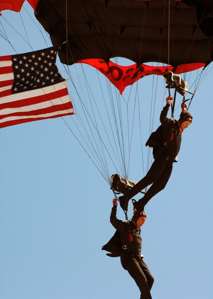 U.S. Army Black Daggers float high above Air Show crowds with our nation's flag at Barksdale Air Force Base, Louisiana, on April 21, 2007. This event marked the begining of the Defenders of Liberty Air Show 2007 while some of Barksdale's Officers sung the National Anthem. (U.S. Air Force photo by Airman 1st Class Joanna M. Kresge)