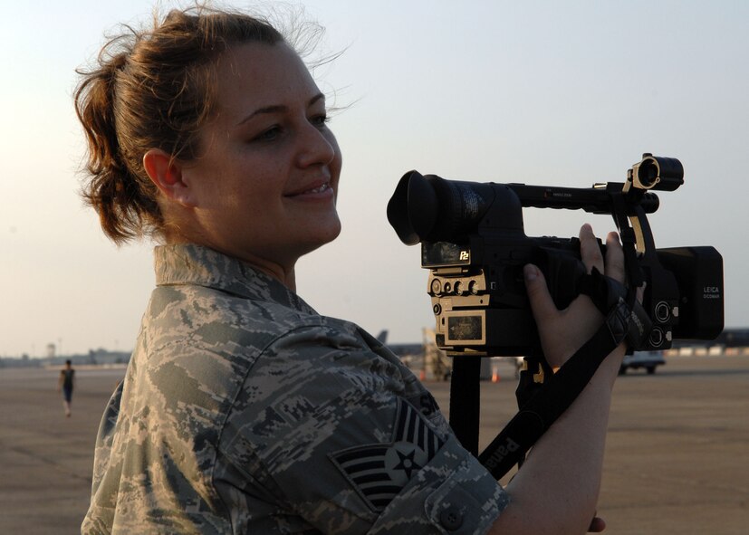 BARKSDALE AIR FORCE BASE, La. - Tech Sgt. Laura Smith, 2d Bomb Wing Public Affairs, records the Navy Top 40 New Orleans band during the 2008 Twilight portion of the Defenders of Liberty Air show here May 9. (U.S. Air Force photo by A1C Brittany Y. Bateman)