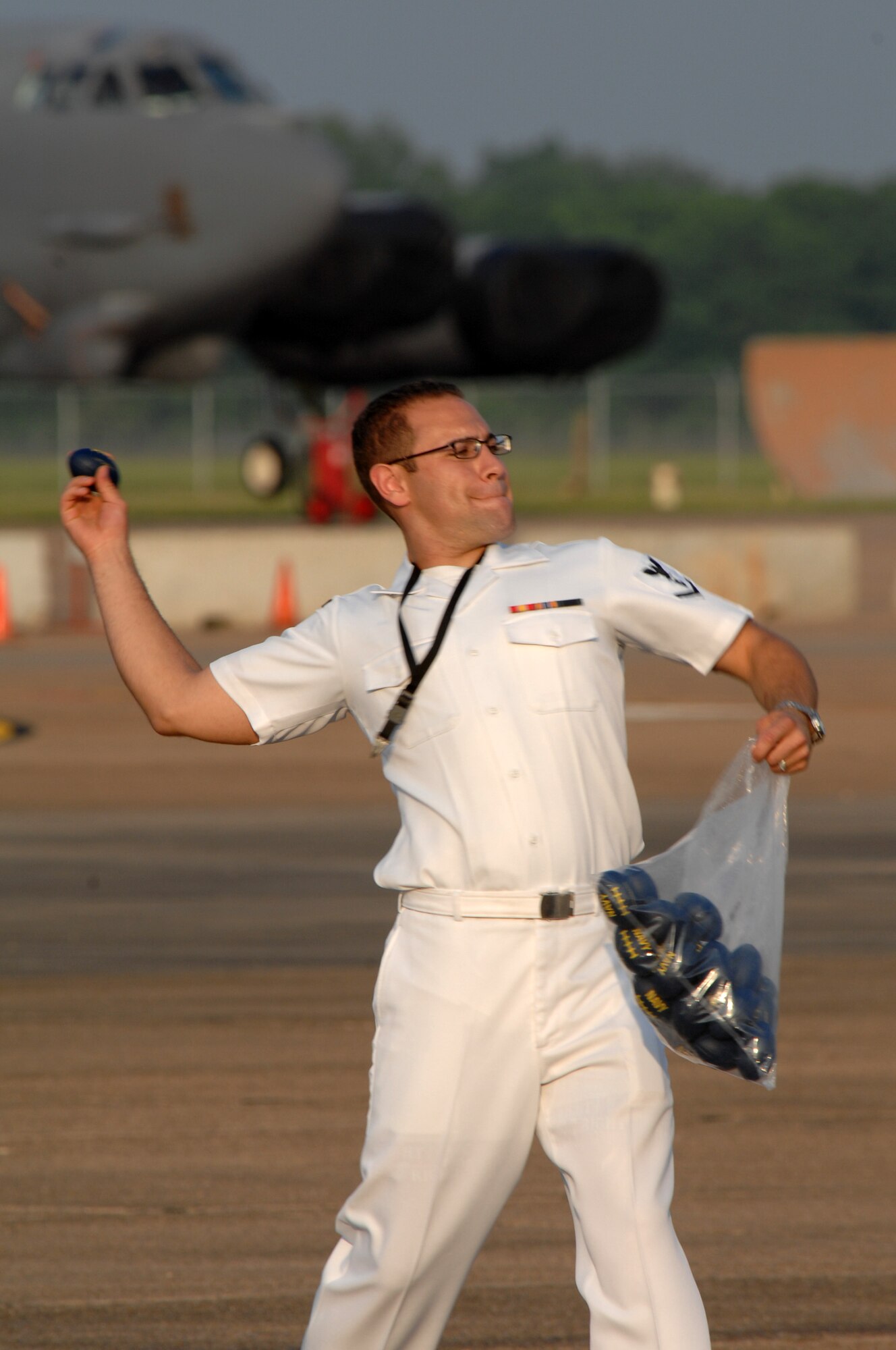 BARKSDALE AIR FORCE BASE, La. - A member of the Navy Top 40 Band New Orleans throws mini-footballs into the crowd during their concert on May 9. The Navy band performed during the twilight portion of the Defenders of Liberty Air Show. (U.S. Air Force photo by Airman 1st Class Joanna M. Kresge)