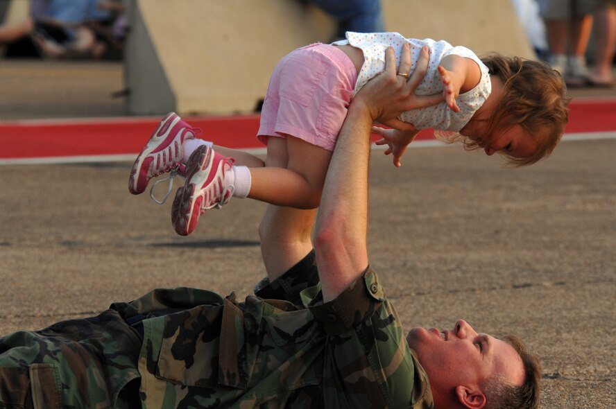 BARKSDALE AIR FORCE BASE, La. - Maj Craig Blood plays with his daughter Alyssa, 3, during a concert by the Top 40 Navy Band from New Orleans, La. on May 9. The Navy Band was performing as part of the twilight portion of the Defenders of Liberty Air Show. (U.S. Air Force photo by Airman 1st Class Joanna M. Kresge)