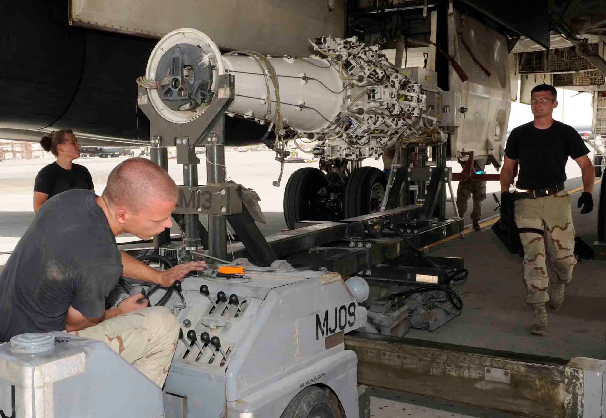 Airman 1st Class Thomas Howe operates a MJ-40 bomb lift truck while Staff Sgt. Jacob Sherwood guides him into position to install a 2,000-pound conventional rotary launcher in the aft weapons bay of a B-1 Lancer at a Southwest Asia air base May 7. They are assigned with 379th Expeditionary Aircraft Maintenance Squadron and deployed from Ellsworth Air Force Base, S.D. (Tech. Sgt. Johnny Saldivar)