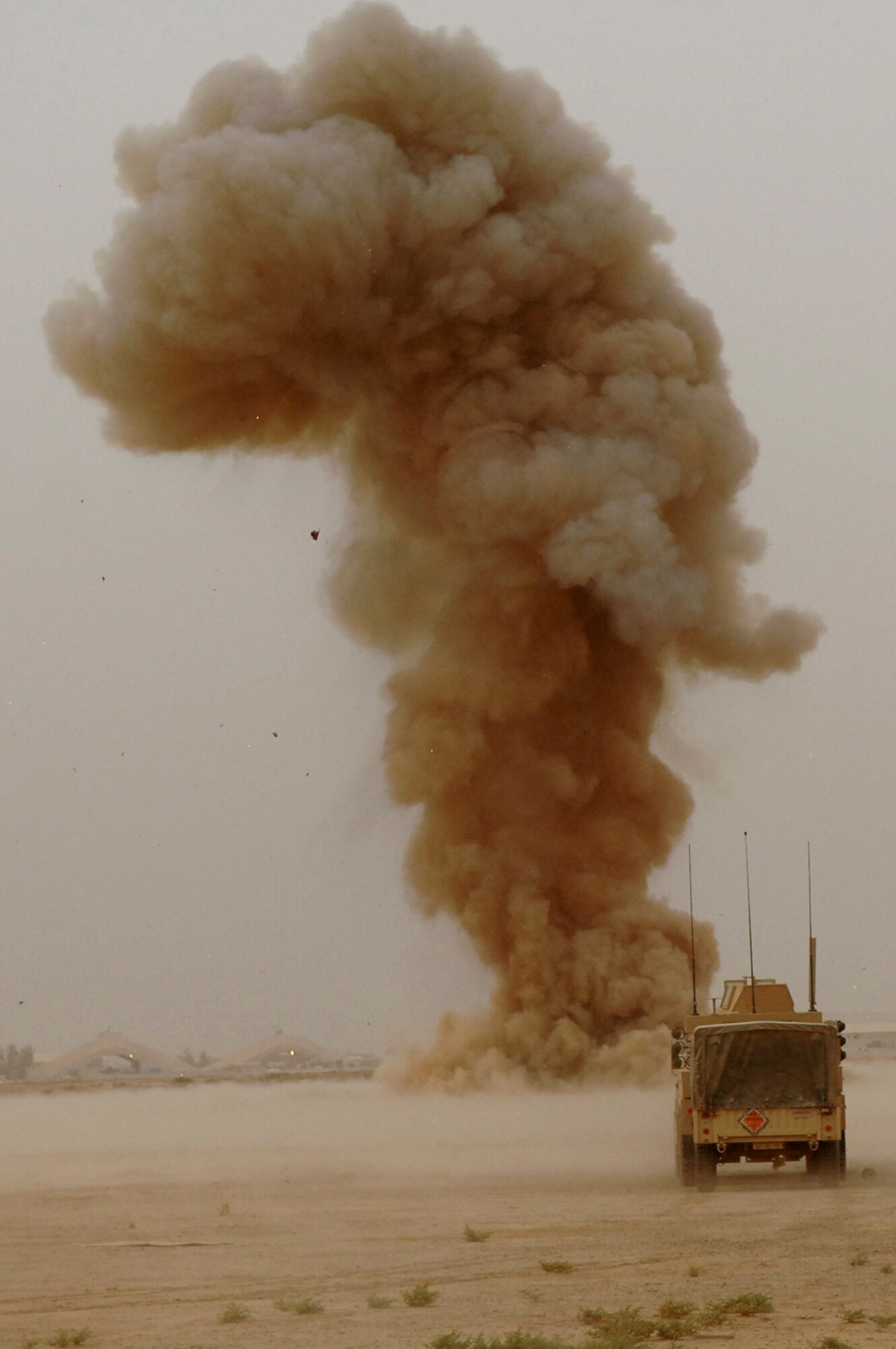 BALAD AIR BASE, Iraq -- A plume of smoke rises 1,500 feet into the air after a controlled detonation of various munitions here, May 9. Controlled detonations are executed by members of the 332nd Expeditionary Civil Engineer Squadron explosive ordnance disposal team and are a means of disposing of unexploded ordnances to ensure they cannot be used by enemy forces. (U.S. Air Force photo/ Senior Airman Julianne Showalter)
