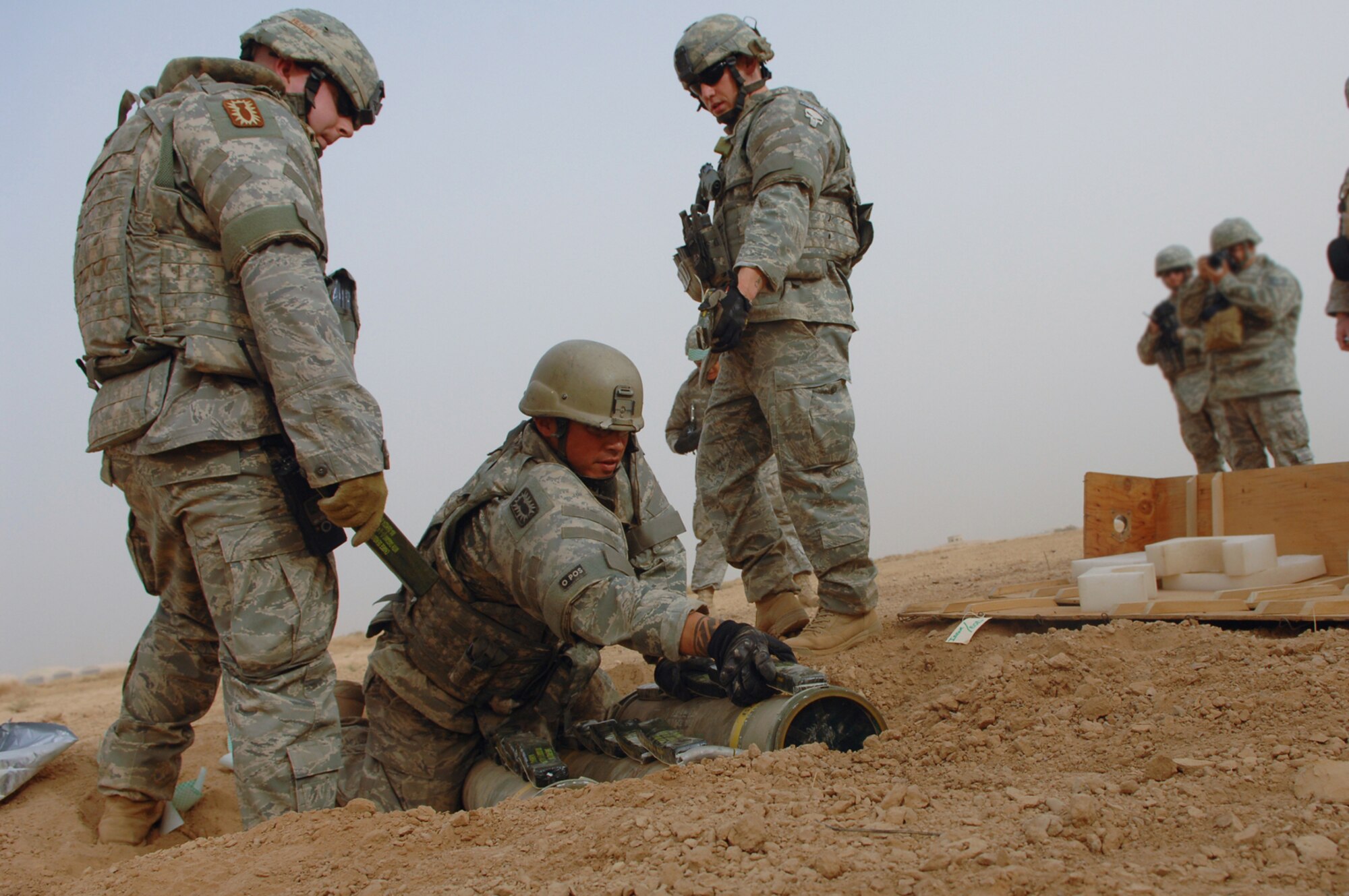 BALAD AIR BASE, Iraq -- Airmen assigned to a 332nd Expeditionary Civil Engineer Squadron explosive ordnance disposal team, place C-4 onto three 40-pound unserviceable guided missiles here, May 9. The team collects unexploded ordnances from various locations and detonates them so they do not fall into the hands of enemy forces. (U.S. Air Force photo/ Senior Airman Julianne Showalter) 