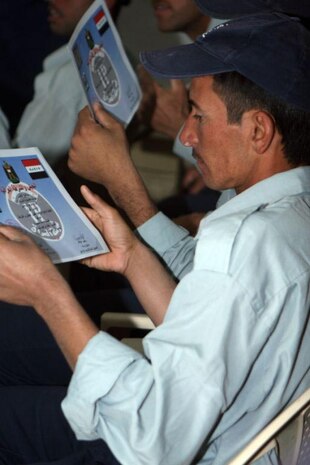 A recently graduated Iraqi Policeman glances over his certificate of completion from Al Anbar Ramadi District Training Headquarters May 8. Upon graduating from the training, the policemen go to their precinct and officially begin working as an Iraqi Police Officer. "The policemen will go to a variety of different stations within all of the Ramadi precincts almost immediately after they graduate or as soon as their station directs them to report," said Capt. Gerard C. Dempster, Headquarters and Service Company Commander with 1st Battalion, 9th Marine Regiment, Regimental Combat Team 1 and direct liaison to the Iraqi Security Forces.