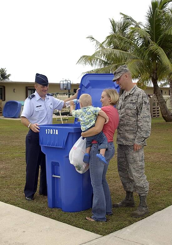 Krischan Cox, son of Senior Airman Jeffrey Cox 36th Civil Engineer Squadron, put the first recycling material in the new recycling bins introduced May 5. The new recycling bins will be distributed to base housing occupants on a rotational basis. (U.S. Air Force photo by Airman 1st Class Carissa Wolff)