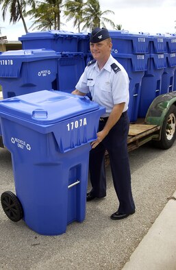 Col. Gregory Cain 36th Wing Vice Commander removes a new recycling bin straight from the truck when they were introduced May 5. The new recycling bins will be distributed to base housing occupants on a rotational basis. (U.S. Air Force photo by Airman 1st Class Carissa Wolff)