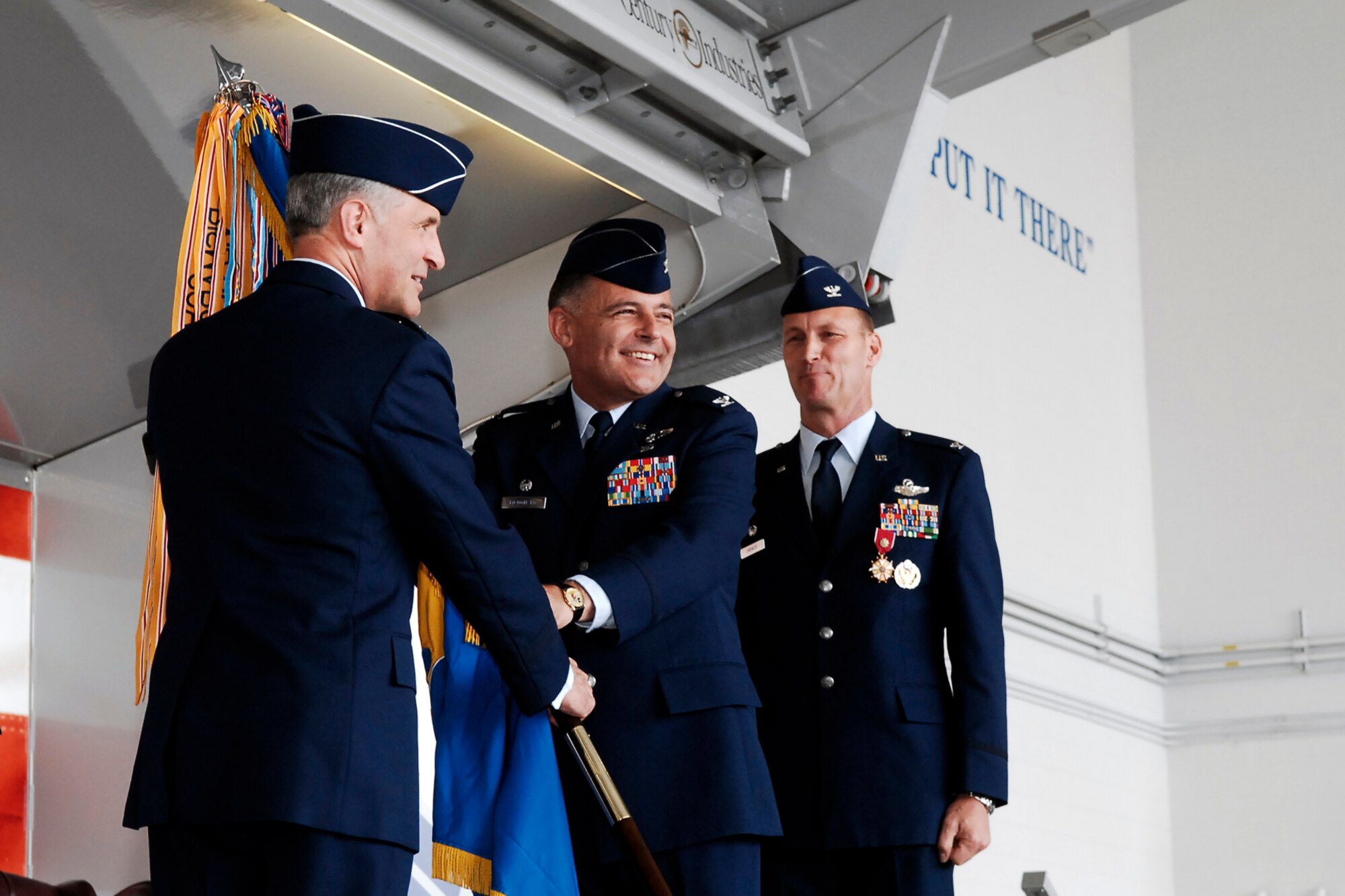 Maj. Gen. James Hawkins, 18th Air Force Commander, poses for a photo with the new 43rd Airlift Wing Commander, Col. John McDonald, during a change of command ceremony May 6 at Pope. Colonel McDonald was the 43rd AW Vice Commander for Col. Timothy Zadalis (background), the outgoing 43rd AW Commander. Colonel Zadalis has been selected for promotion to brigadier general and will be taking command of the 21st Expeditionary Mobility Task Force at McGuire Air Force Base, N.J. (U.S. Air Force Photo by Mike Murchison)